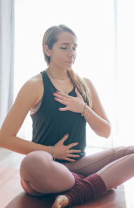 Person practicing diaphragmatic breathing to improve posture and reduce back and neck pain