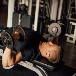 Person experiencing front shoulder pain during a push-up exercise