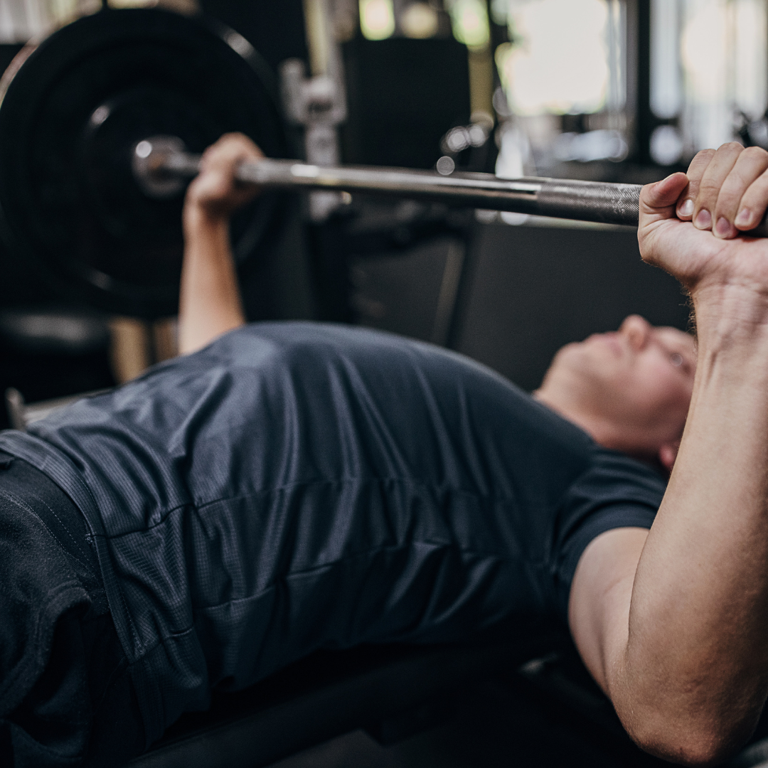 Side-by-side comparison of a painful barbell bench press and a rehab-focused bench press with no weight, demonstrating improper vs. proper technique.