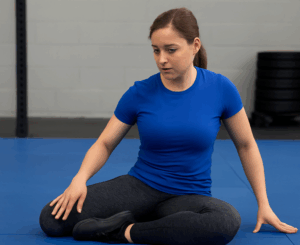 Athlete performing a hip mobility drill to address persistent hip pain